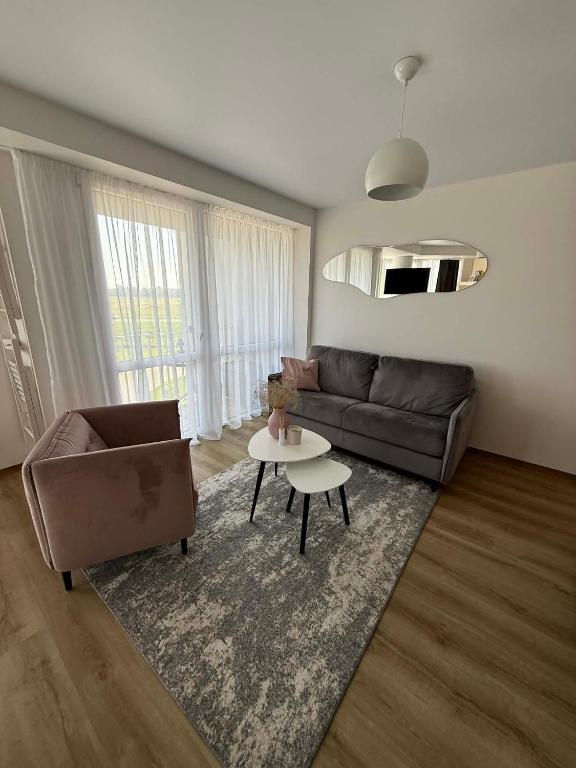 a living room with a couch and a table at Breeze Studio in Palanga