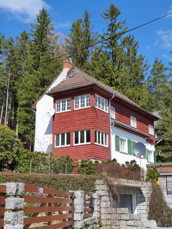 a red and white house on top of a hill at Willa Burzynin in Karpacz