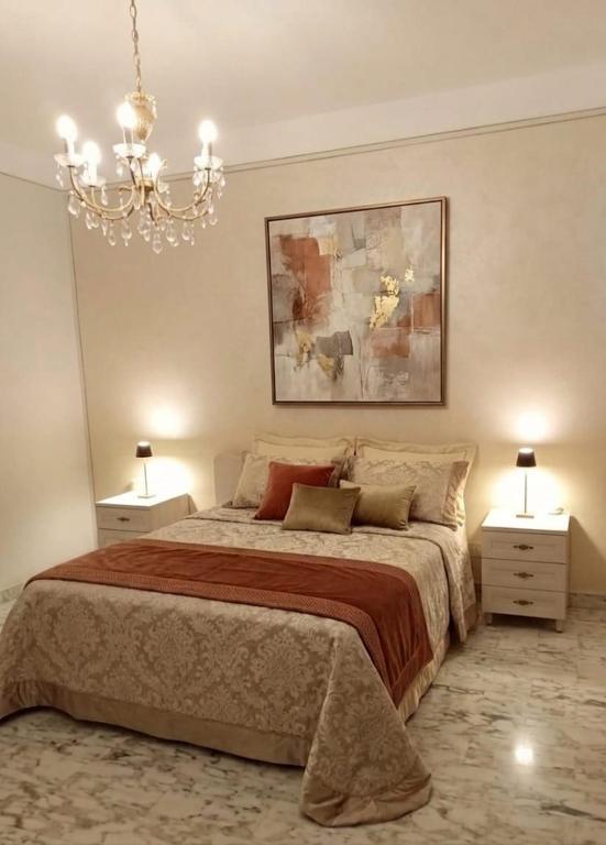 a bedroom with a large bed with two night stands at Miky M House in Venosa