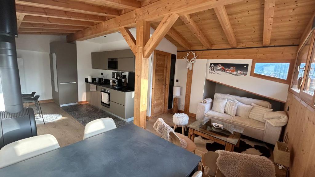 a living room with a table and a couch at Portes du Soleil T3 "comme un chalet" direct access Morzine Avoriaz in Montriond
