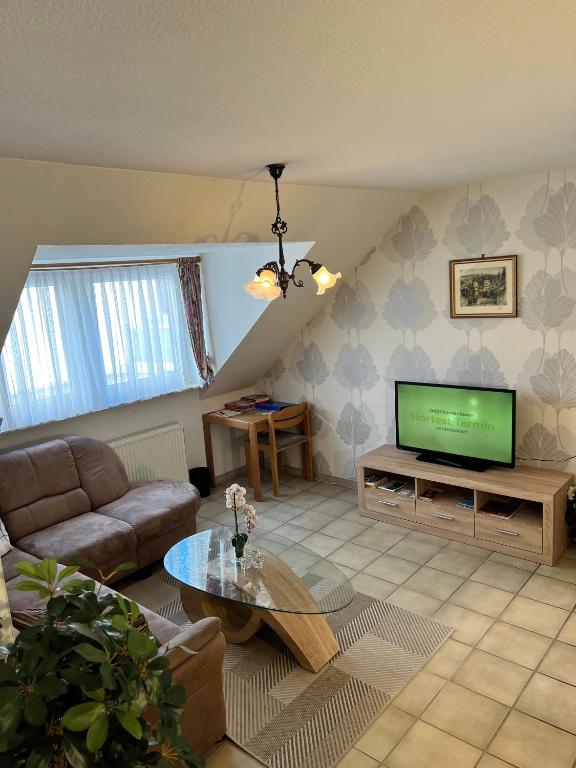 a living room with a couch and a television at Ferienwohnung 4 in Bernkastel-Kues