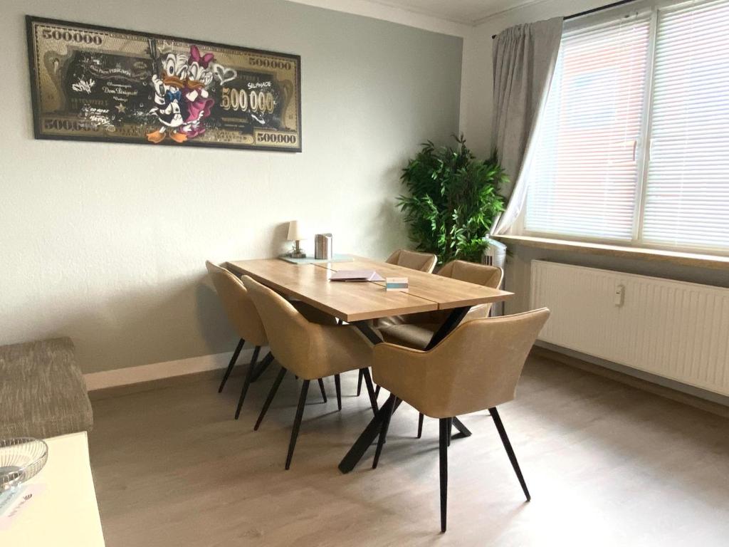 a dining room with a wooden table and chairs at Ferienwohnung Freedom 1 Sky Terrasse High End in Northeim