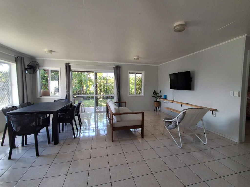 a living room with a ping pong table and a tv at Akaroa Hideaway in Avarua