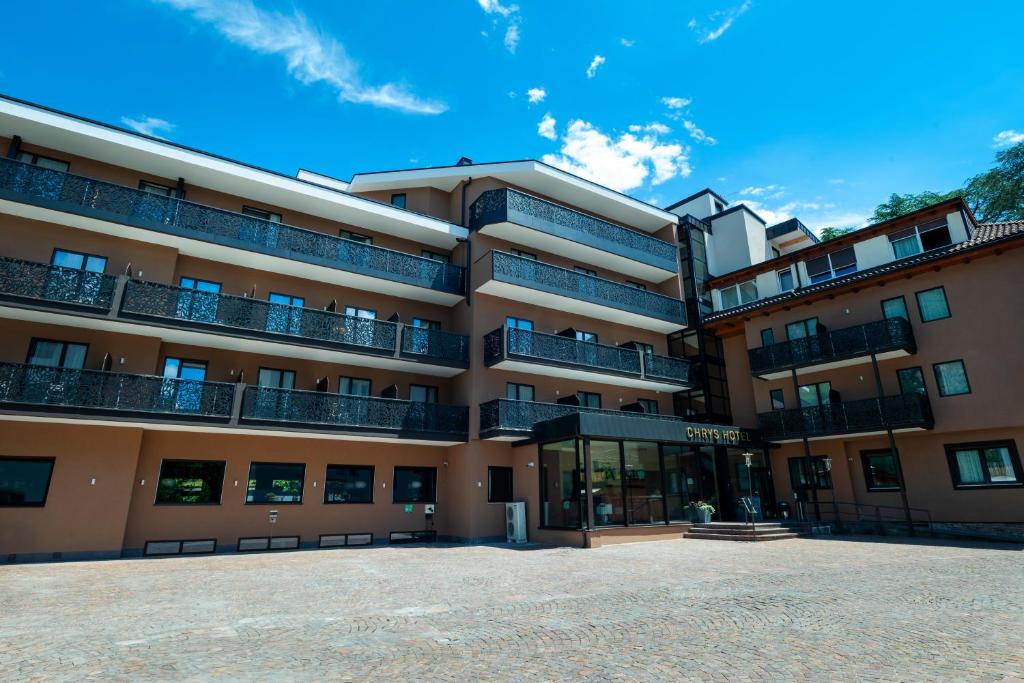 a large apartment building with a lot of balconies at Hotel Chrys in Bolzano