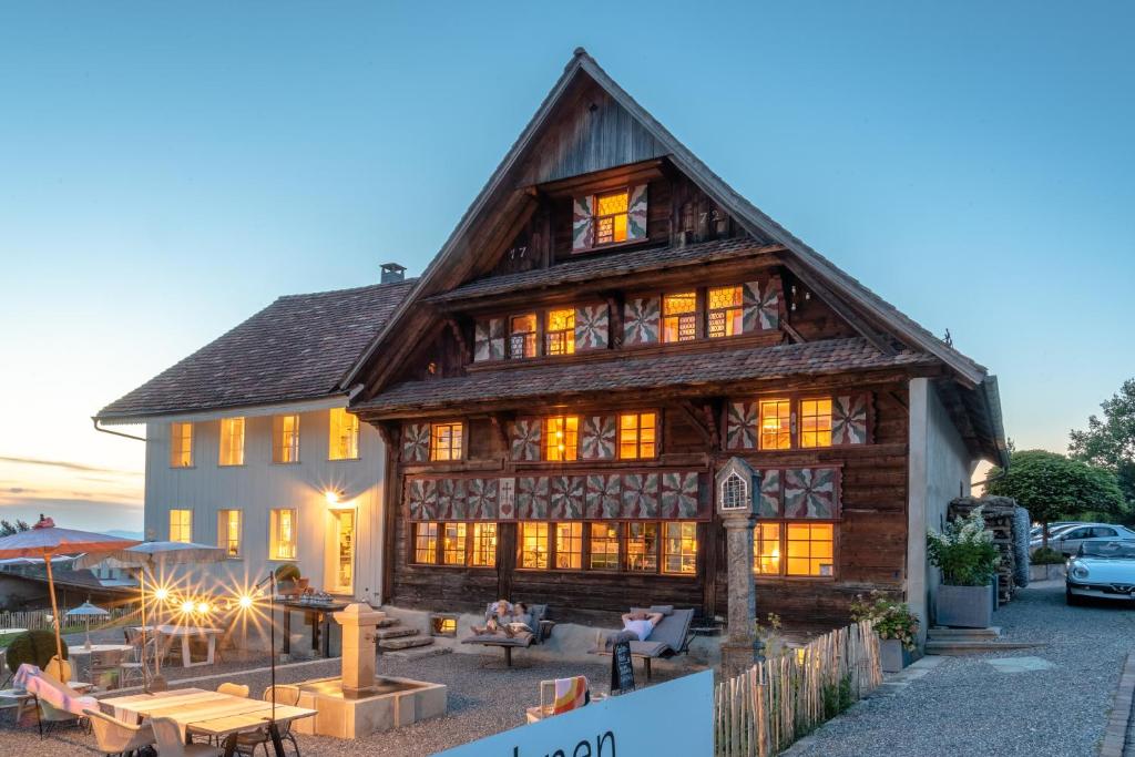 a large wooden house with lights on at Keiser`s Kammer in Meisterschwanden