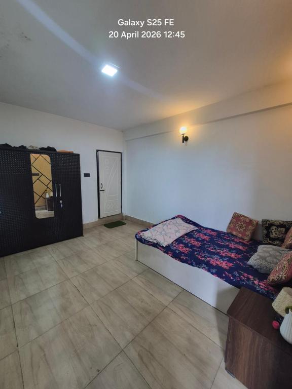 a room with a bed and a couch in it at Happy Farmstead in Darjeeling