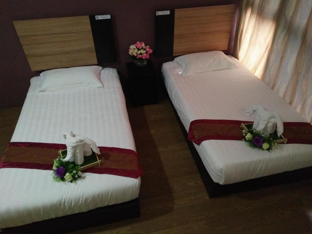 Postel nebo postele na pokoji v ubytování Amigo Hotel