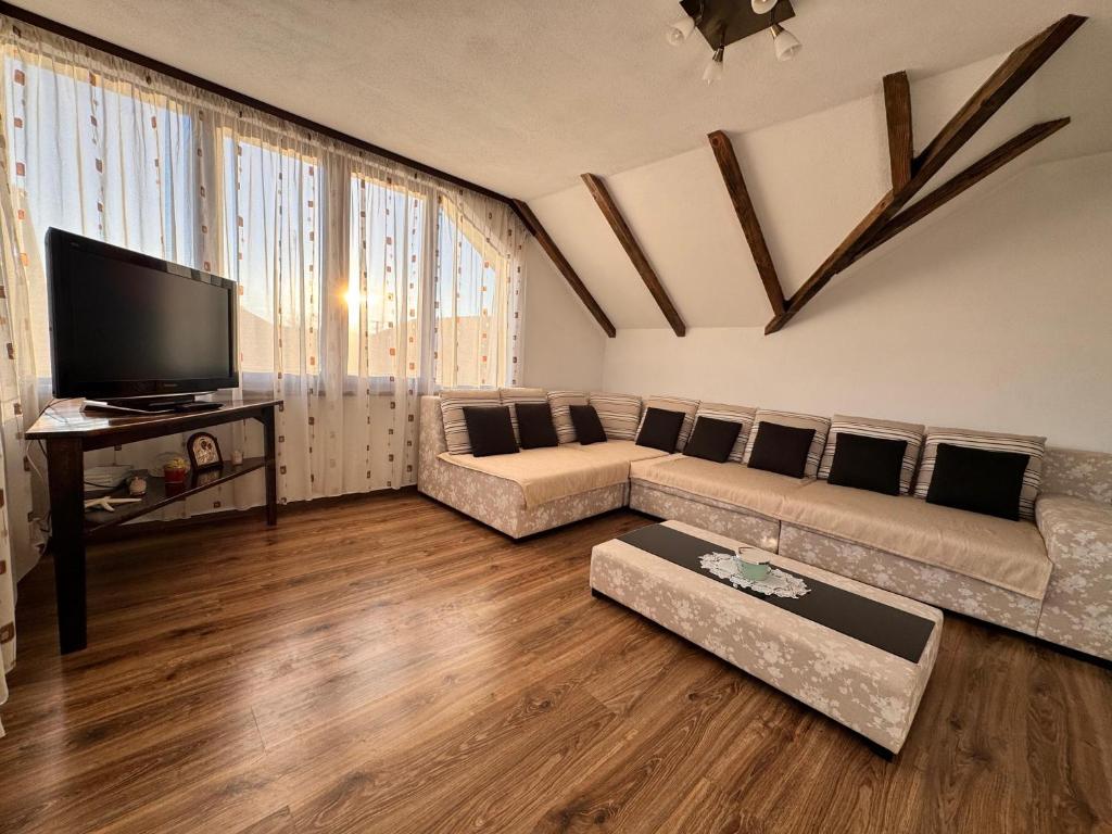 a living room with a couch and a flat screen tv at Voila House in Voila