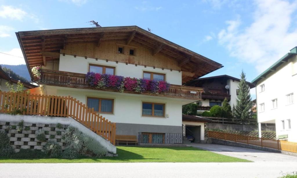 a house with a balcony with flowers on it at Appartement Wurm- nahe Hochzillertal für Familien in Kaltenbach