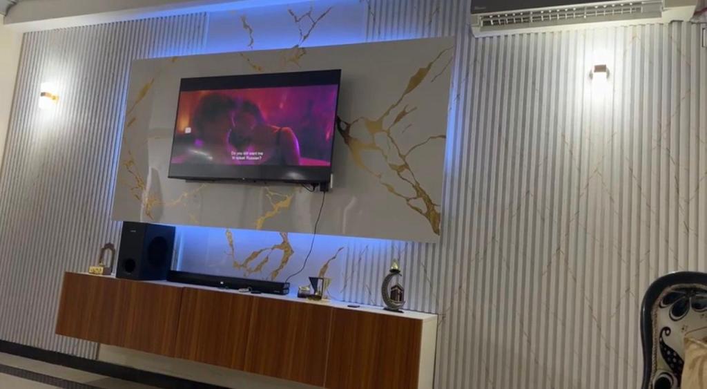 a flat screen tv on a wall in a room at Ahfash Homes in Mombasa