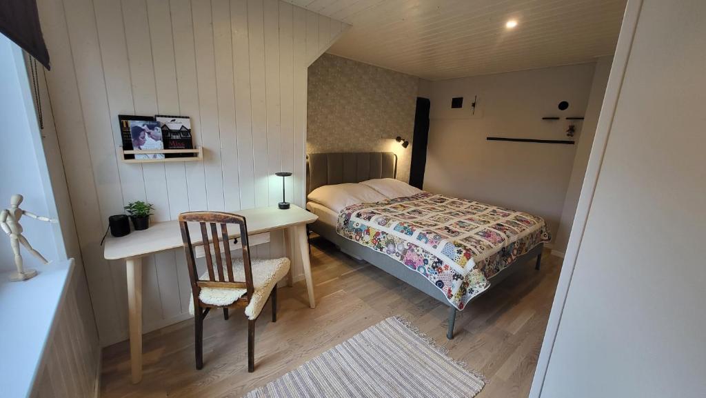 a bedroom with a bed and a desk and a chair at Kose apartment in Kose