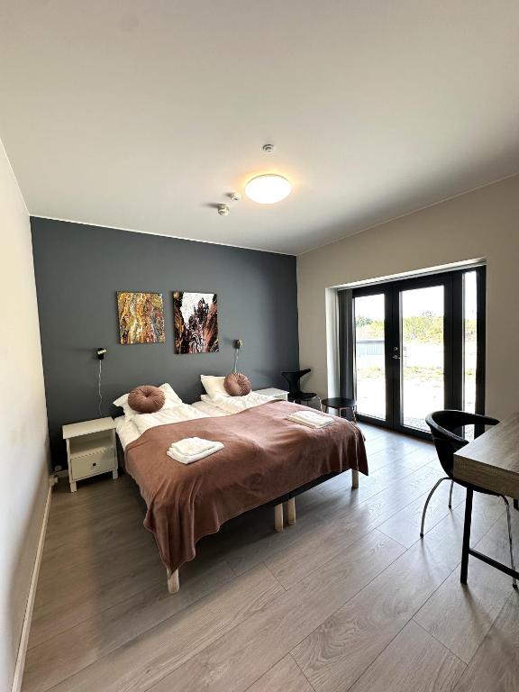 a bedroom with a large bed and a table at Torghatten Lodge in Torget