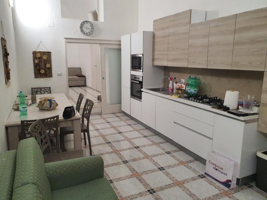 a kitchen with a counter and a table in a room at Residenza Delizia in Gallipoli