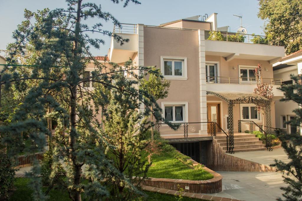 a large house with trees in front of it at Hotel Vila Bregu in Tirana