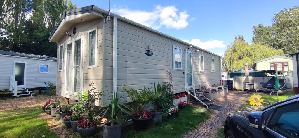 a tiny house in a yard with plants at Billing Aquadrome ,2 bedrooms, Royale Poplar KM 12 in Great Billing