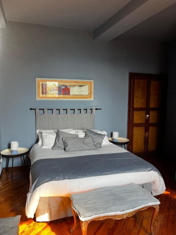 a bedroom with a large bed and two tables at Locanda Orticello in Monferrato in Cremolino