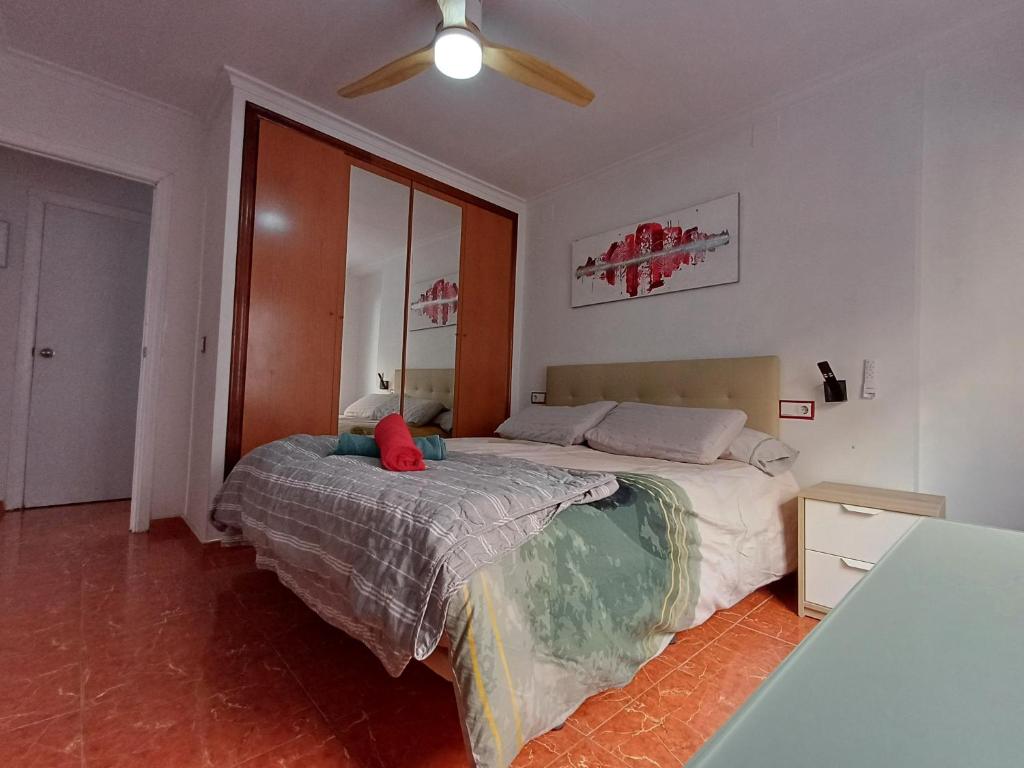 a bedroom with a bed and a ceiling fan at GERMANIES HOME y Garaje , Algemesí Home in Algemesí