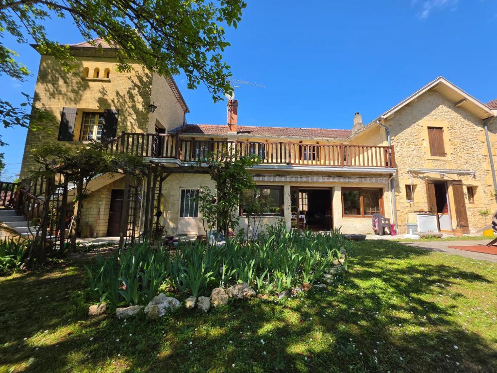 an old stone house with a porch and some plants at Les Pierres Du Périgord 200 in Couze-et-Saint-Front