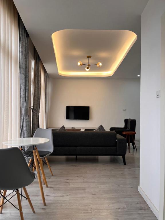a living room with a couch and a tv on a ceiling at Zemilo Hotel Apartment in Addis Ababa