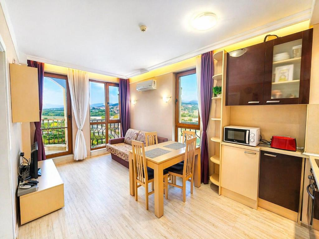 a kitchen and a living room with a table and a kitchen and a couch at Harmony Dream Island 9 Private Apartment 618 in Sunny Beach