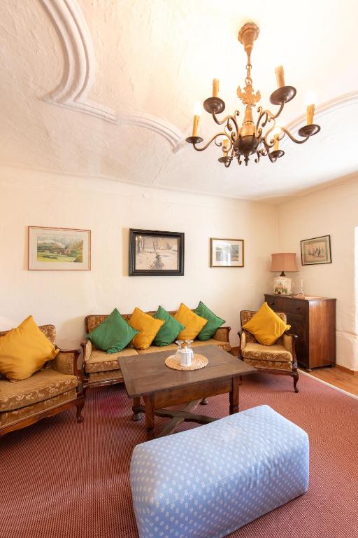 a living room with a couch and a table at Ferienwohnung Ottmanach Schlosshof in Pischeldorf
