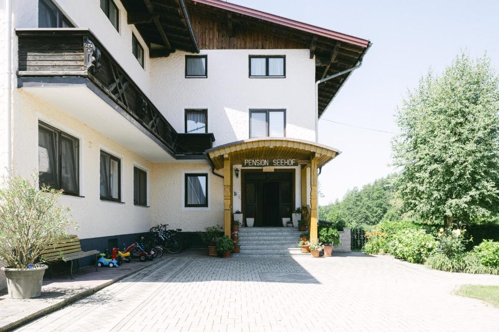 a building with a staircase leading to the front door at Pension Seehof in Holzöster