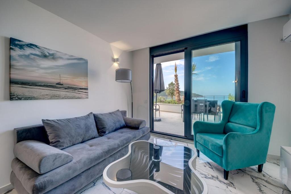 a living room with a couch and a chair at Beach Apartments in Ulcinj