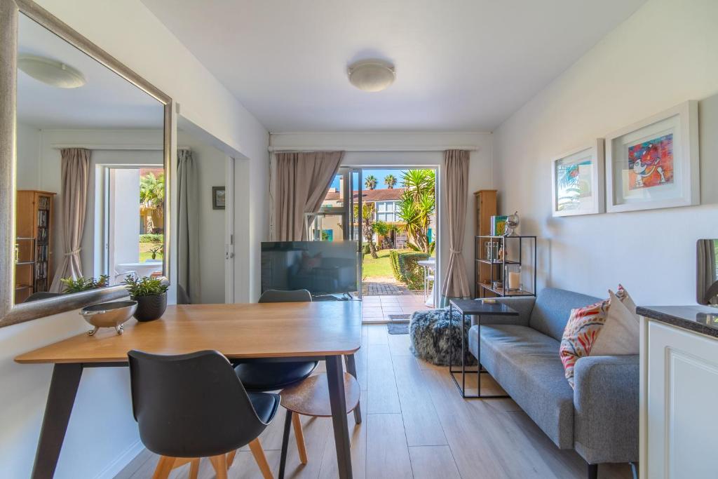 a living room with a table and a couch at Zenith Place, Port St Francis in Cape St Francis
