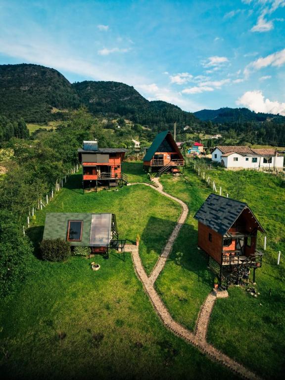 an aerial view of a farm with houses on a hill at Glamping Hakuna Matata in Monguí