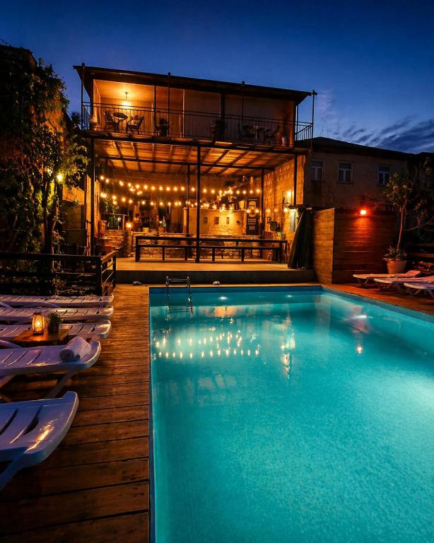 a swimming pool in front of a house at night at Villa Provance & Swimming Pool in Sighnaghi