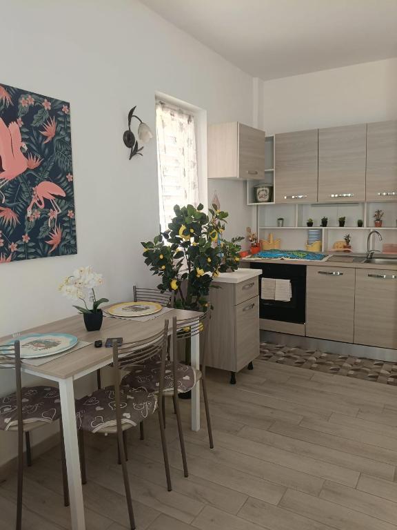 a kitchen with a table and chairs and a dining room at La conchiglia in Motta San Giovanni