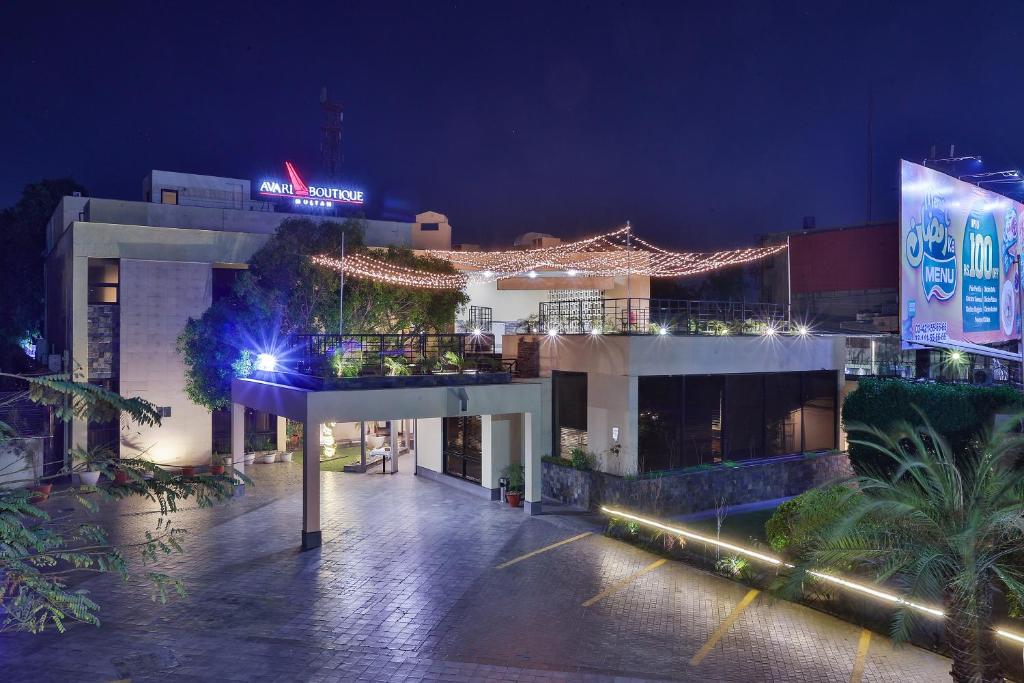 a large building with lights on it at night at Avari Boutique Multan in Multan