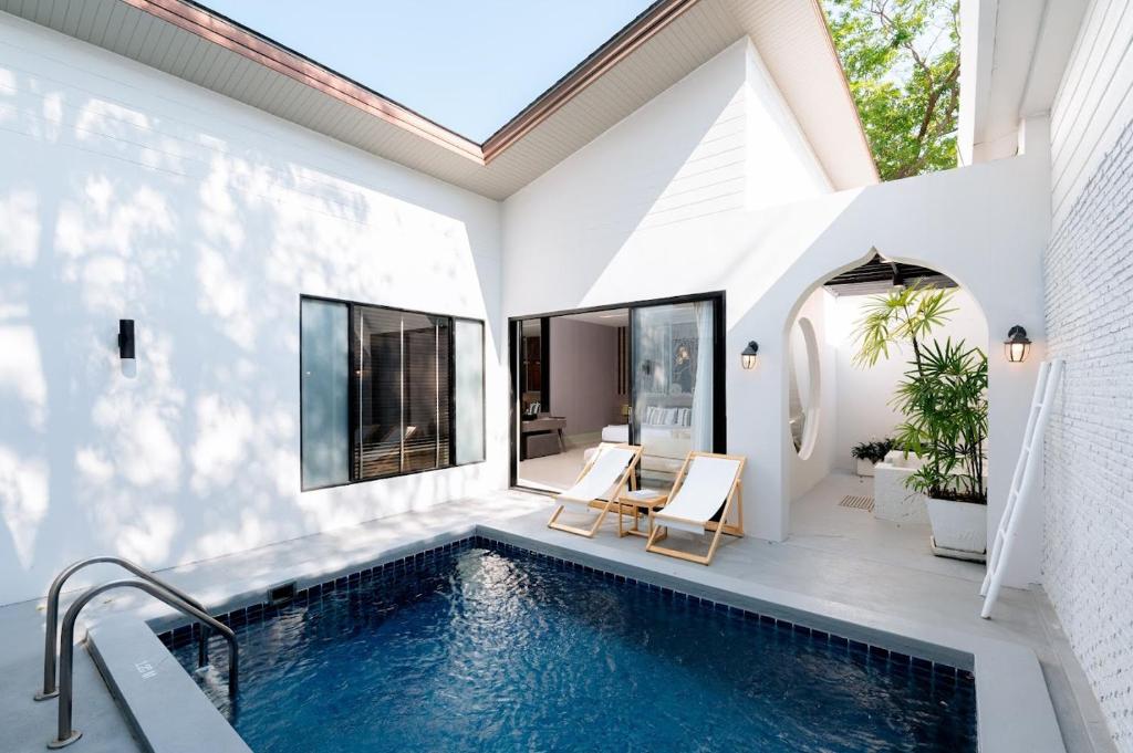 a swimming pool in the backyard of a house at Cae Villa Hua Hin in Hua Hin