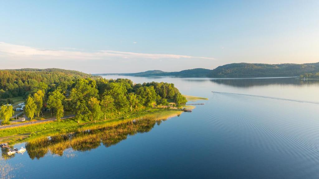 an aerial view of a river with trees on the shore at Skotteksgarden Lakefront Cottages and Camping near Ulricehamn in Ulricehamn