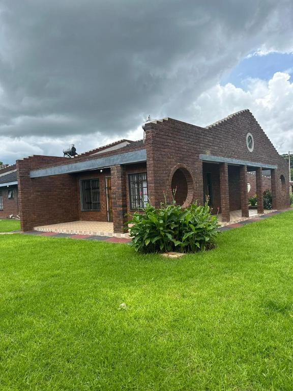 a brick house with a lawn in front of it at The Savannah Escape in Norton