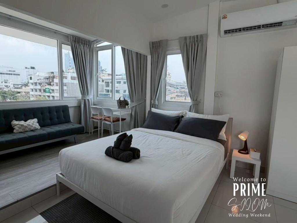 a bedroom with a bed with a teddy bear on it at Prime Silom in Bangkok