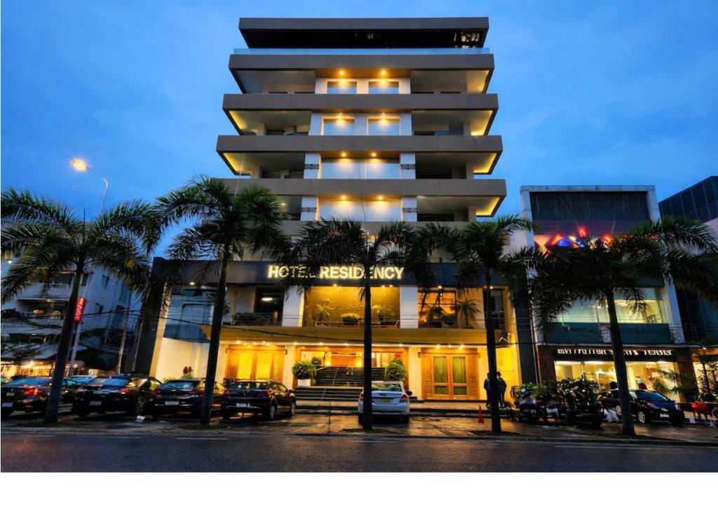 a building with a hotel next to a parking lot at Hotel Residency in Jalandhar