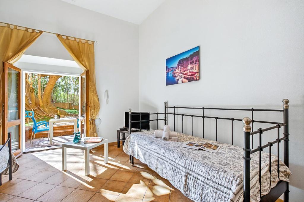 a bedroom with a bed and a table at Residence Argentiera in Miniera dellʼArgentiera