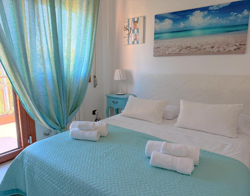 a bedroom with a large bed with towels on it at LE TERRAZZE Apartment - spacious and charming apartment near the sea and beach, close to the train station with hourly trains to Rome - Lido delle Sirene, Anzio in Anzio