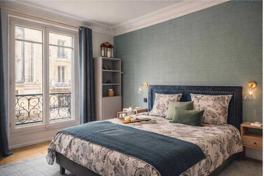 a bedroom with a large bed and a window at Maison Luxembourg - Chambre privée in Paris