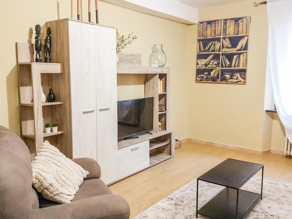 a living room with a large white entertainment center at Nel Centro Storico in Luserna San Giovanni