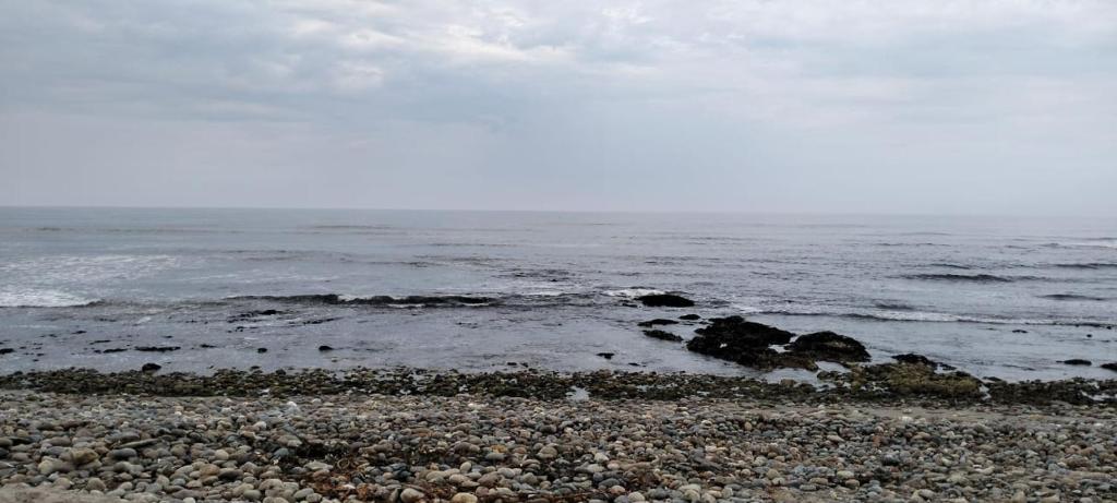 a rocky beach with the ocean in the background at On the Beach 20 in Swakopmund