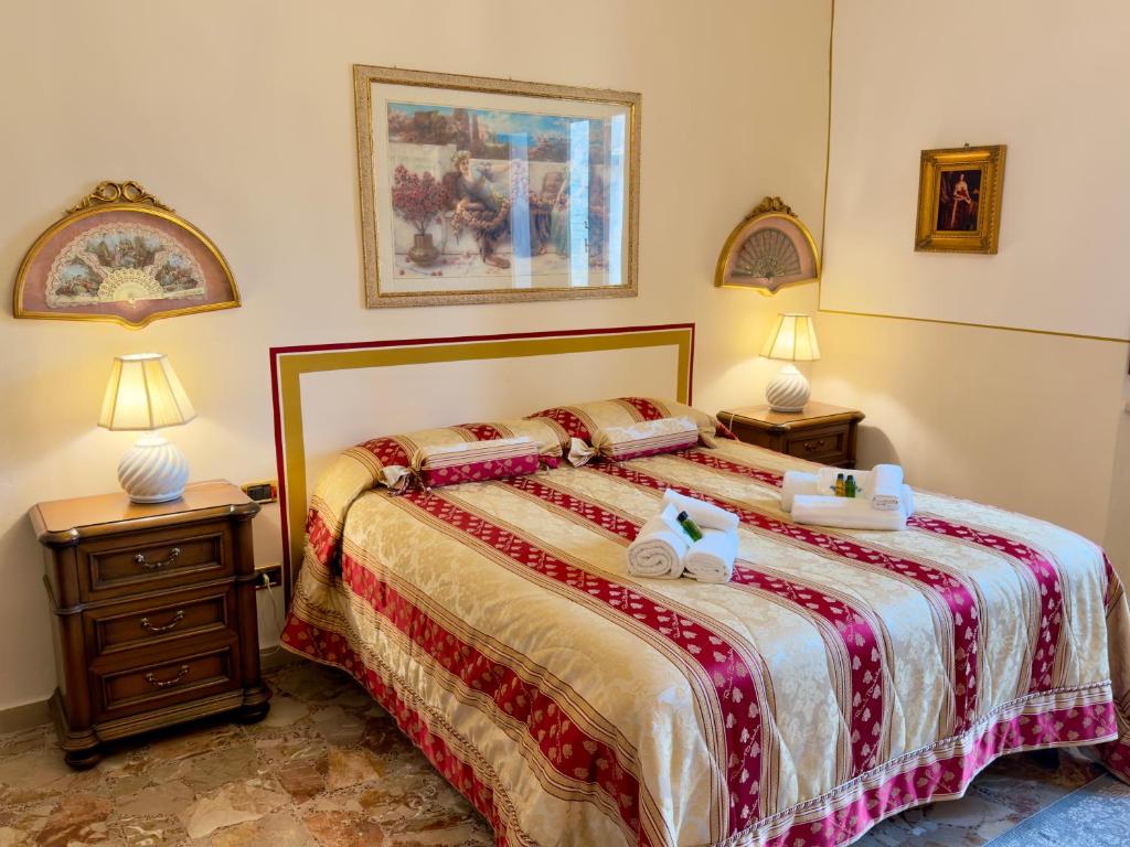 a bedroom with a large bed with two night stands at Suite Apartment Mandorlo in Volterra