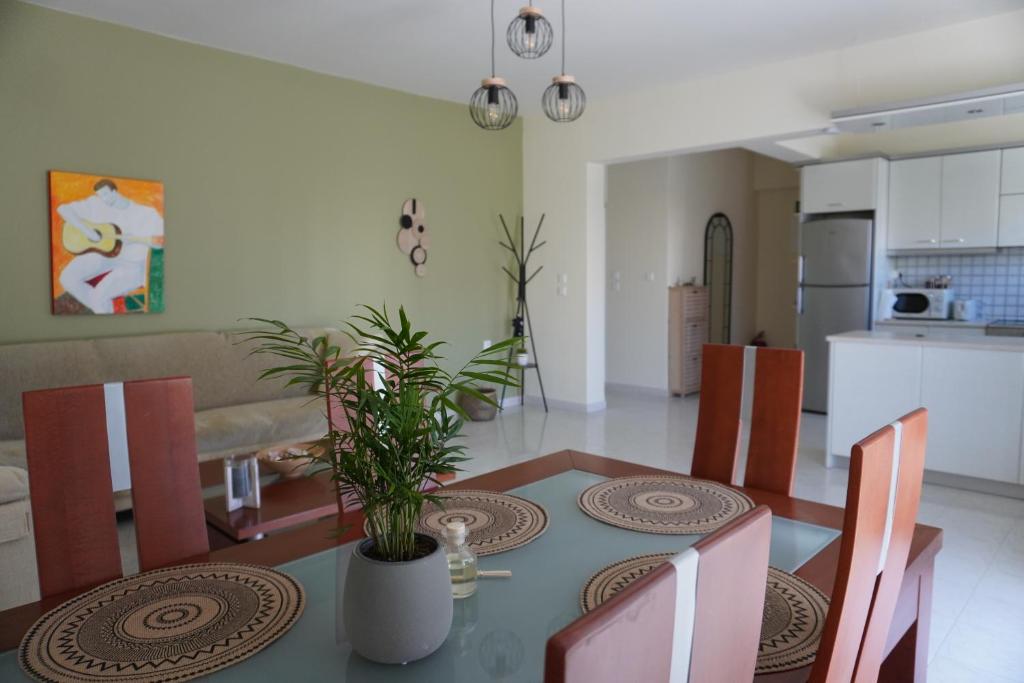 a dining room table with chairs and a kitchen at El Condor Casa in Rhodes Town