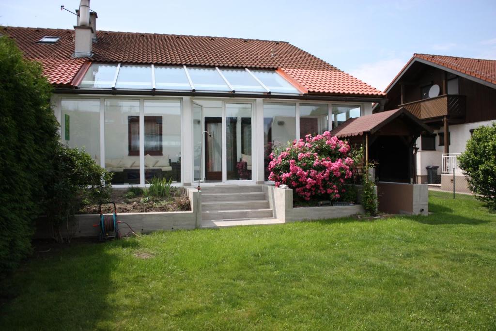 Una casa blanca con un porche con flores. en Haus zum Wohlfühlen, en Viena