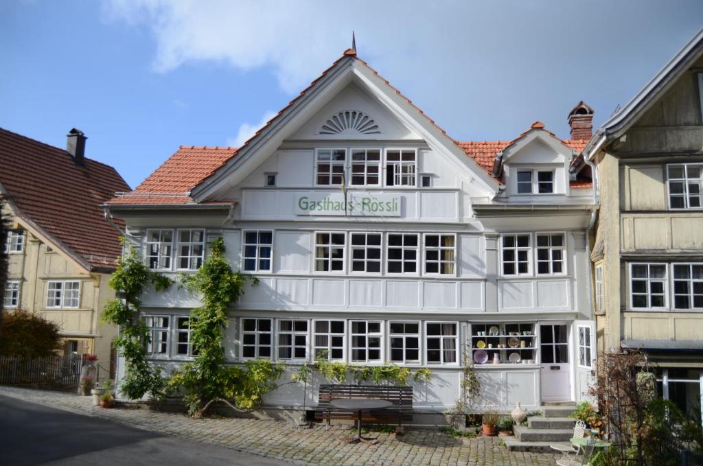 a white building with a sign on it at Gasthaus Rössli in Trogen