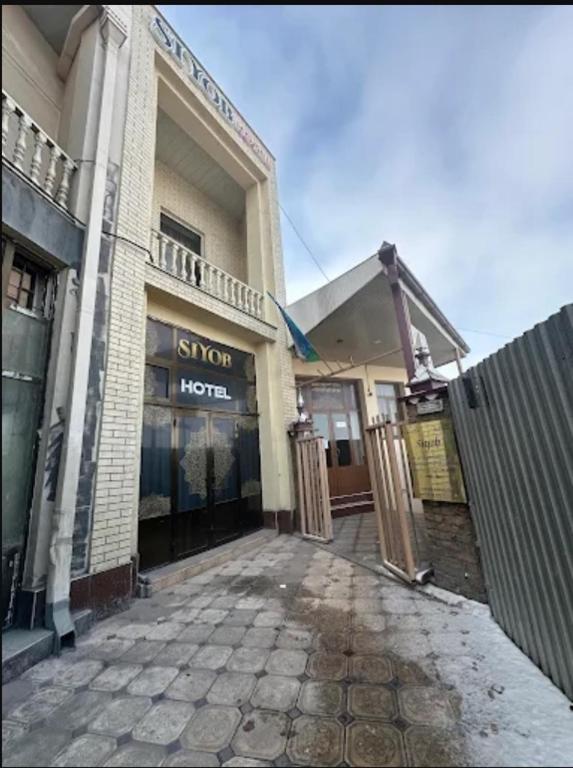 a building with a sign for a hotel at Hotel & Hostel Siyob Samarkand in Samarkand