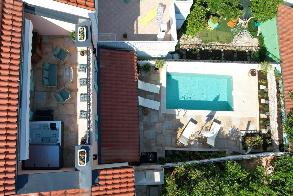 an overhead view of a house with a swimming pool at Heritage Holiday Home Rafica 365 Wellness Retreat in Božava