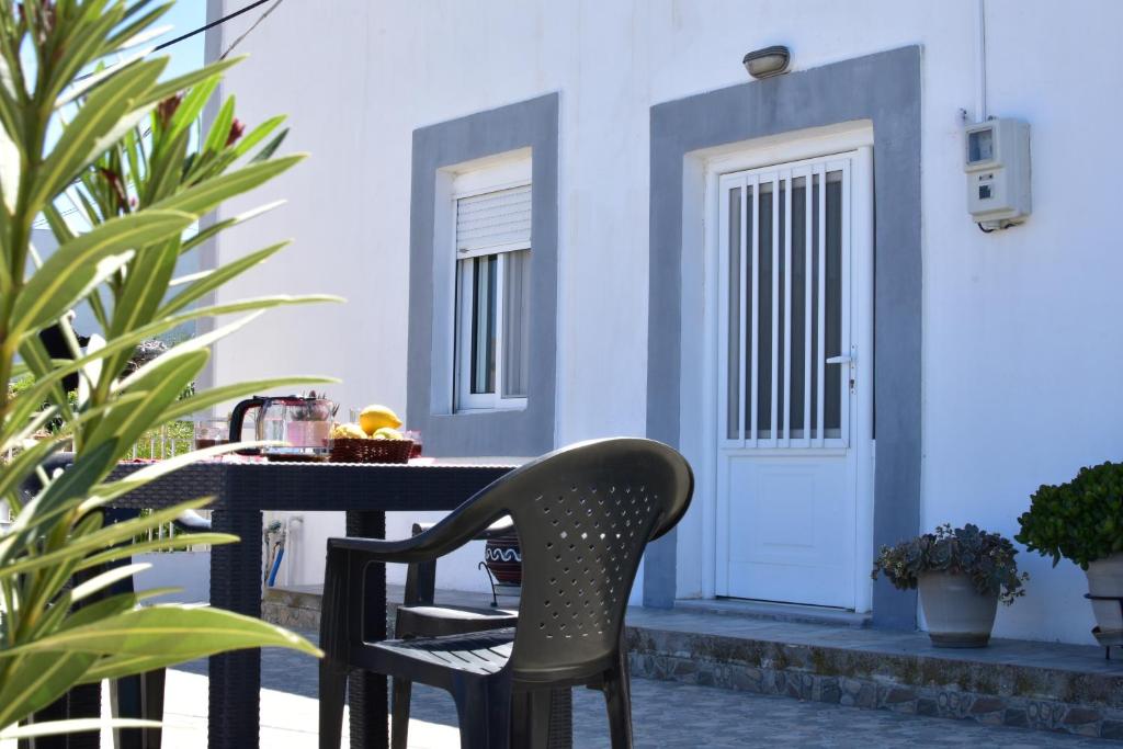 a chair sitting at a table in front of a house at Despina in Kritinía