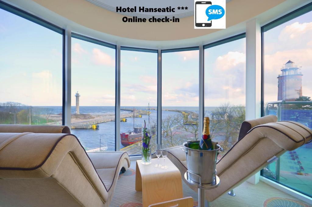 a living room with a view of the ocean and a lighthouse at Hotel Hanseatic - Adults Only in Kołobrzeg